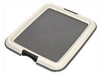 Top view of plastic pee pad holder showing beige frame and dark gray tray
