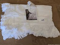 Folded white Cortina sham with retail tag showing image and branding