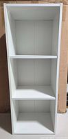 Front view of assembled white three-tier Furrino bookshelf