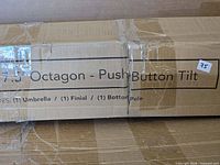 Cardboard box showing product labeling 'Octagon – Push Button Tilt' and size sticker