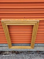 Full view of bamboo frame leaning on orange door