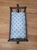 Top view of cradle showing mattress pad inside slatted frame