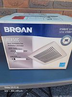 Front of boxed Broan AER50C exhaust fan