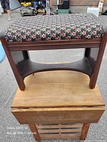 Overall view of wood footstool on another surface