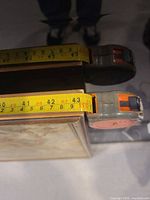 Width measured with tape; shows frame edge and tape reading