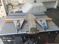 Router table top with fence and router motor visible