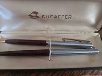 Ballpoint pen and mechanical pencil inside open Sheaffer case