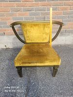 Front view of chair showing velvet upholstery and wood frame