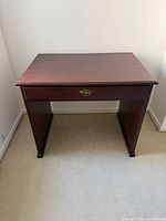 Front view of wooden desk with drawer