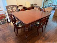 Dining table with four chairs around it