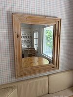 Front view of the wood double border mirror on wall