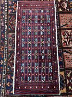 Full view of the Baluchi wool mat showing overall pattern