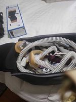 CPAP components inside bag: hose, masks, headgear