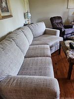 Full view of sectional along wall showing length, seat and back cushions