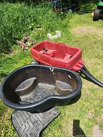 Overall view of pond liner, red wagon, mats beneath
