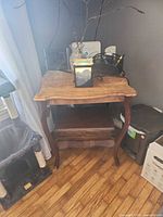 Full view of wooden two-tier plant stand showing top and lower shelf