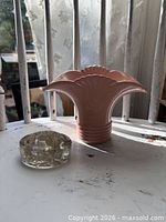 Pink ceramic vase and clear glass flower frog side by side