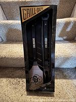 Front of boxed Colorado Buffaloes grill set showing two utensils and logos