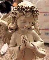 Front view of praying angel planter showing facial detail, rose crown, and clasped hands