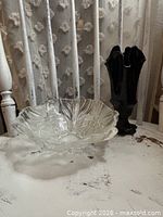 Black glass handkerchief vase and clear floral candy dish together