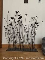 Front view of full metal floral sculpture showing stems and flower cups
