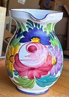Front view showing floral motif and spout