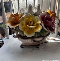 Front view of Capodimonte porcelain urn with multicolored roses and two doves
