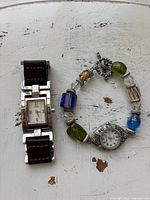 Front view of both watches displaying dials and straps