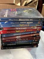 Stack of 11 Disney/Pixar DVDs side view
