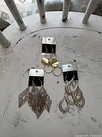 Overview of all three pairs of earrings on tabletop