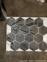 Front view of one mesh-mounted sheet showing black hex stone tiles
