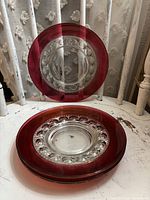 Stack of four King’s Crown plates showing ruby rim and clear center