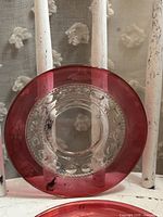 Front view of one saucer showing ruby rim and clear center