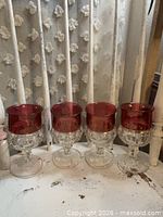 Front view of four matching ruby flash wine goblets