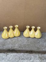 Front view of both yellow triple vases
