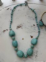 Full view of turquoise bead necklace laid flat