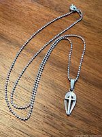 Pendant attached to full bead chain laid out