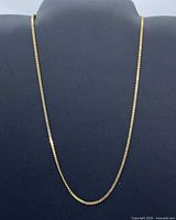 Full view of gold herringbone necklace displayed on bust