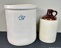 Front view showing both the 5-gallon crock with blue crown mark and the 1-gallon brown-top jug