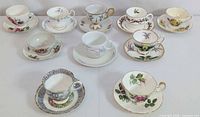 Group shot showing multiple teacup sets, lot item third row right with pink rose pattern