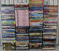 Front view of six tall stacks of assorted children’s, family and educational DVDs/Blu-rays