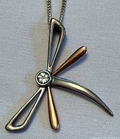 Front view of pendant on chain showing design and clear centre stone