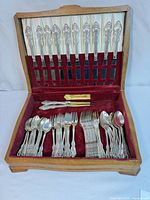 Open flatware chest showing full set arranged in slots