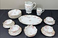 Full lot with plates, cups, saucers, pitchers, platter, bowl displayed