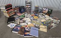 Wide shot of entire lot spread on floor showing books, manuals, discs and boxes