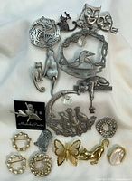 Front view of all brooches laid out on fabric