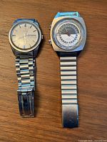 Both wristwatches full view showing bracelets and cases