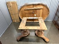 tabletop rear and one pedestal base, leaves wrapped nearby
