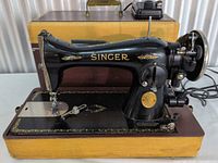 Front left view of Singer sewing machine mounted in case base
