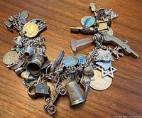 Full view of sterling silver charm bracelet showing variety of charms